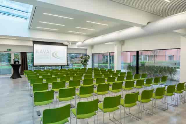 Modern auditorium with green chairs, ready for a vibrant conference or presentation.