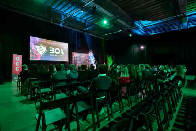 Engaging event setup at Avenue Blackbox with ambient lighting and a large screen.