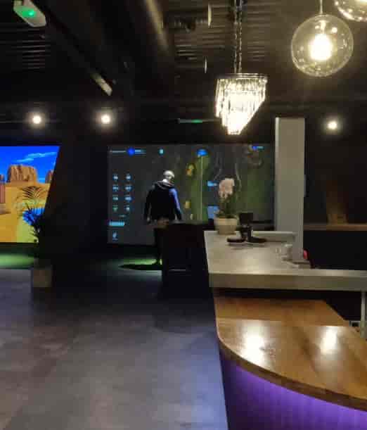 Modern event space at Inner Drive Golf with advanced projection for corporate gatherings.