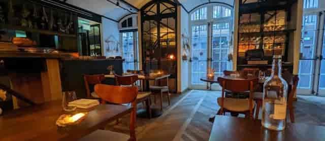 Ekstedt restaurant interior with warm lighting for private dinner and high-end networking events.