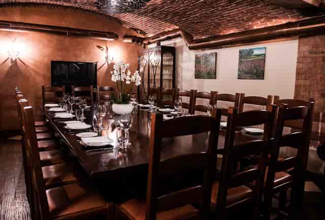 Elegant dining space with rustic brick walls, perfect for private events and meetings.