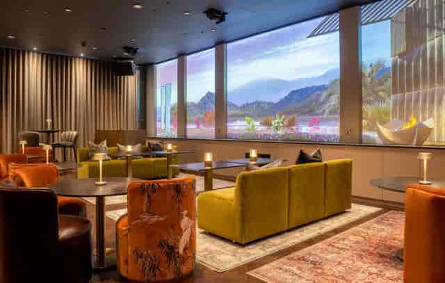 Byrd Lounge at UBA: Modern seating and digital wall for VIP networking and creative workshops.