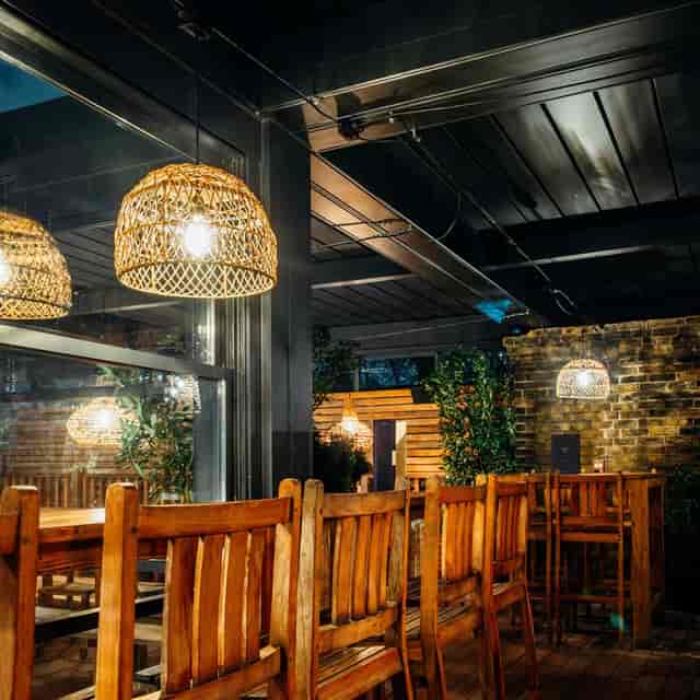 Industrial-chic Orangery at TT Liquor: cozy wooden event space for networking and cocktail parties.