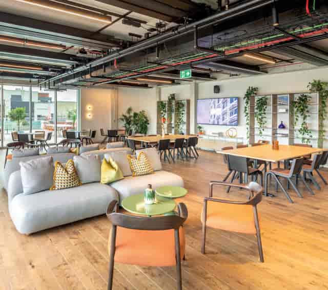 Modern event space, flexible seating, networking, brainstorming.
