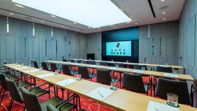 Modern Berlin boardroom with theatre seating, training event.