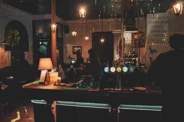 Networking reception at The Lock & Lantern roof terrace featuring atmospheric bar lighting.
