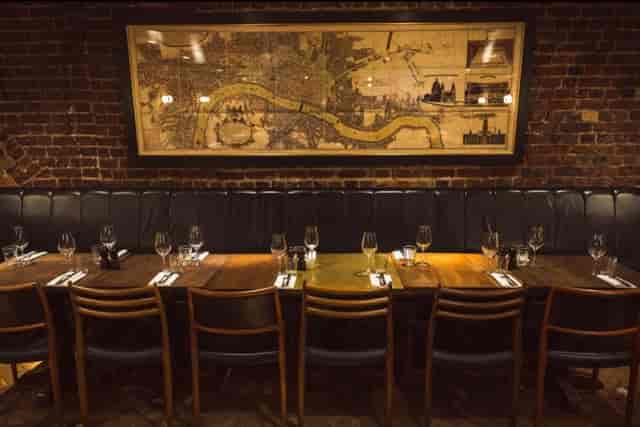 Vesta Tilley Room with leather banquette for intimate boardroom dinner and networking events.