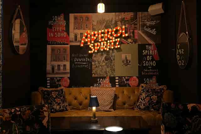 Chic Baaria bar with Aperol Spritz sign. Italian cafe reception, networking event.