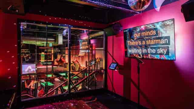 Karaoke event venue, vibrant lighting, team building