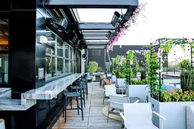 Rooftop deck with retractable roof for networking receptions and corporate events.