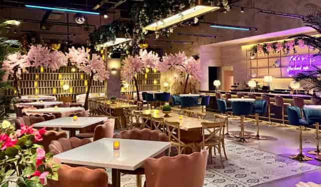 VIP stage front tables at THRōW Social DC with floral decor for private events and parties.