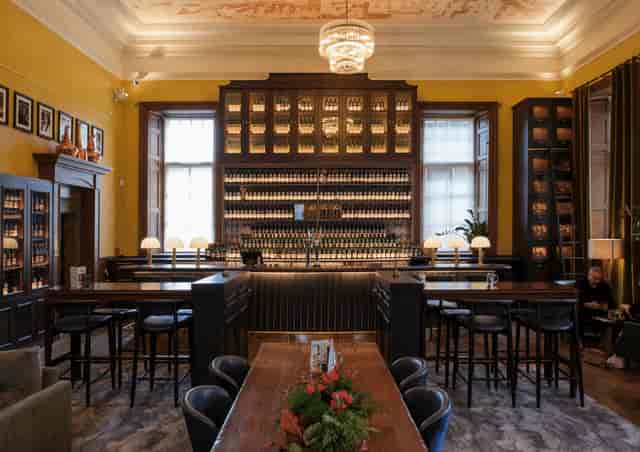 Spirit Safe Room at SMWS: upscale venue with backlit bar for corporate networking and whisky events.