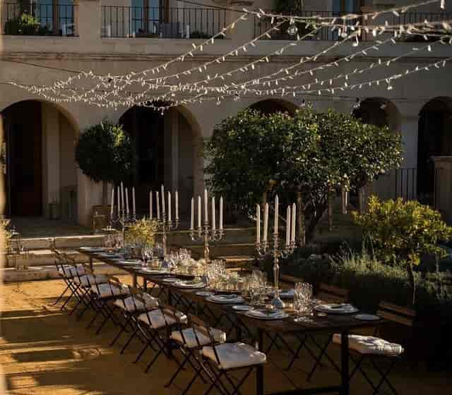 Outdoor gala dinner at Casa Robles: elegant table setting with string lighting for wedding events.