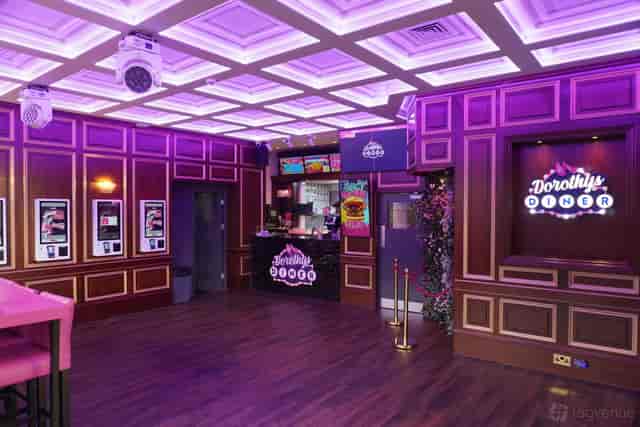 Main Diner pop-up event venue with professional stage lighting and self-service kiosks.