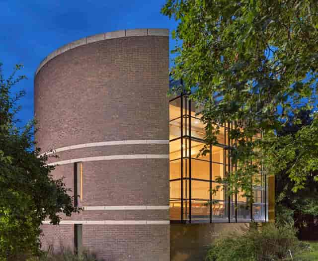 Modern glass-walled Thomas Gray Room at Pembroke College for evening receptions and presentations.