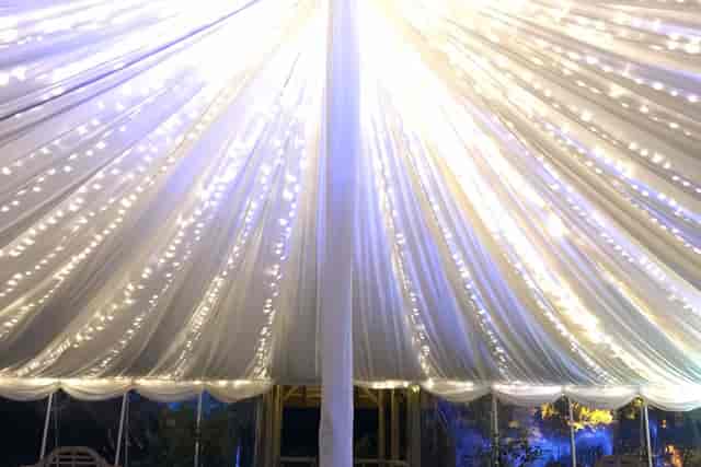 White marquee ceiling with fairy lights for elegant wedding or luxury event venue hire.