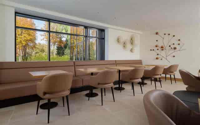 Sion breakout space with banquette seating for corporate networking and business meetings.