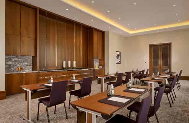 Upscale boardroom with wood decor for professional seminars and corporate training events.
