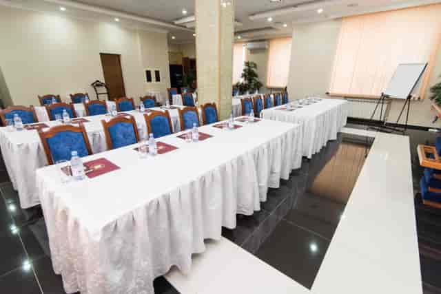 Classroom-style King Hotel Astana conference hall with central structural pillar for event venue.