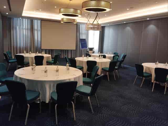 Banquet meeting room with teal chairs at Radisson Blu Nairobi for corporate events or conferences.