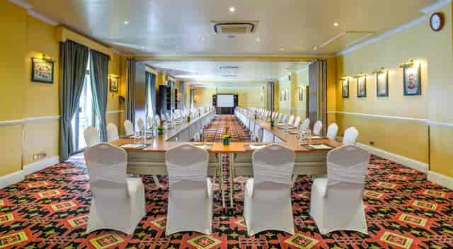 U-shape boardroom at Sarova Stanley Hotel with white chair covers for business meetings.