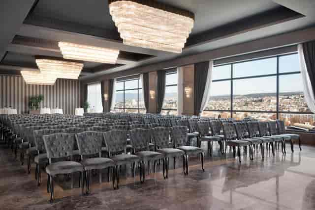 Wyndham Grand Tbilisi ballroom theater setup with tiered chandeliers for corporate event venue.