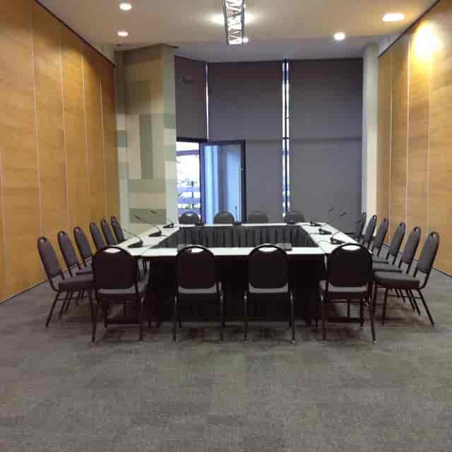 Phase 2 Event Hall: Hollow square boardroom with AV microphones for professional corporate meetings.