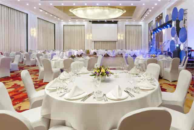 Hualing Ballroom gala dinner setup with professional stage for corporate events and weddings.