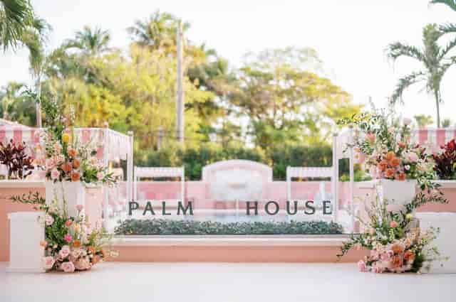 Palm House garden terrace with floral pedestals for luxury brand activation and boutique wedding.