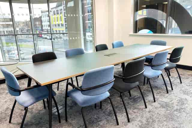 Boardroom-style breakout area with natural light for corporate meetings and team collaboration.