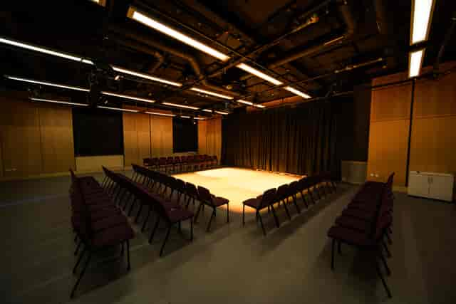 London Youth Theatre black-box studio with U-shaped seating for workshops and presentations.