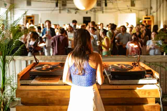 DJ performing at The Hall - Events & Music, industrial-chic networking event venue.