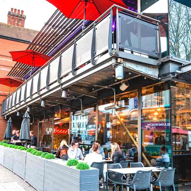 Industrial-chic Tank Lounge at Zerodegrees with retractable roof for corporate happy hour events.
