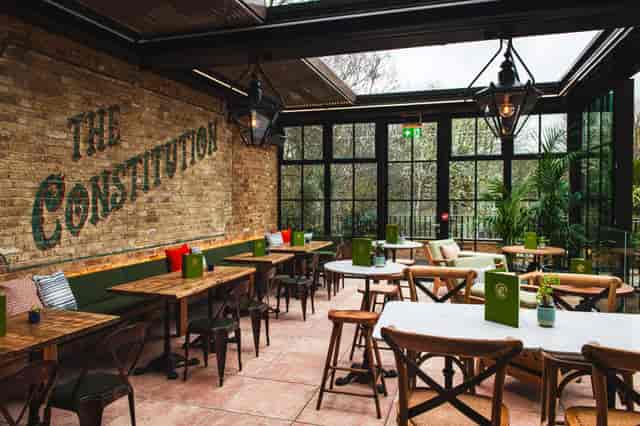 Industrial-chic conservatory at Canal Bar, perfect for corporate networking and team dinners.