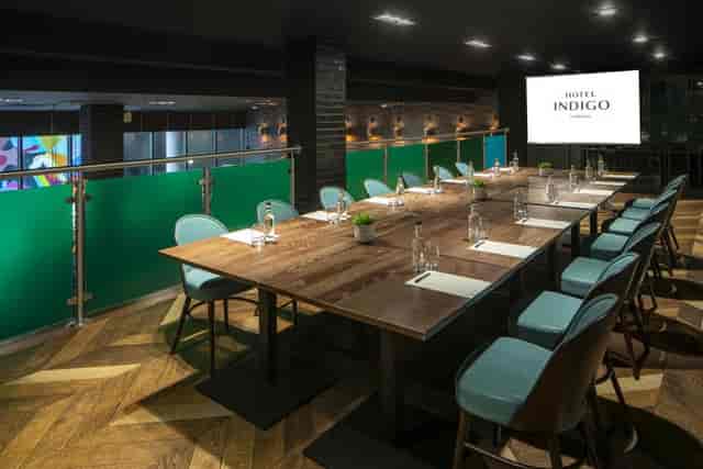 Modern boardroom at Hotel Indigo Liverpool with live-edge table for corporate meetings and events.