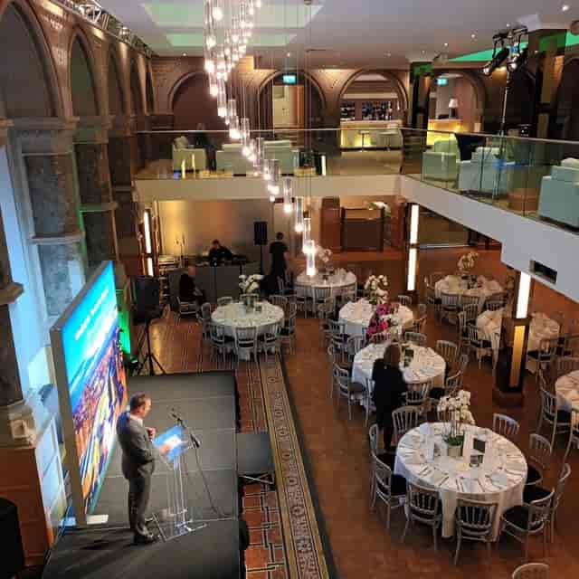 Banking Hall at Aspire Leeds: banquet seating and stage for formal corporate events or conferences.