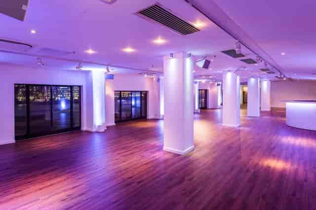 OXO2 blank-canvas event space with purple lighting for receptions and product launches.