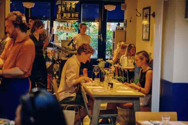 Intimate De Beauvoir Deli buyout space with bistro seating for upscale client reception events.