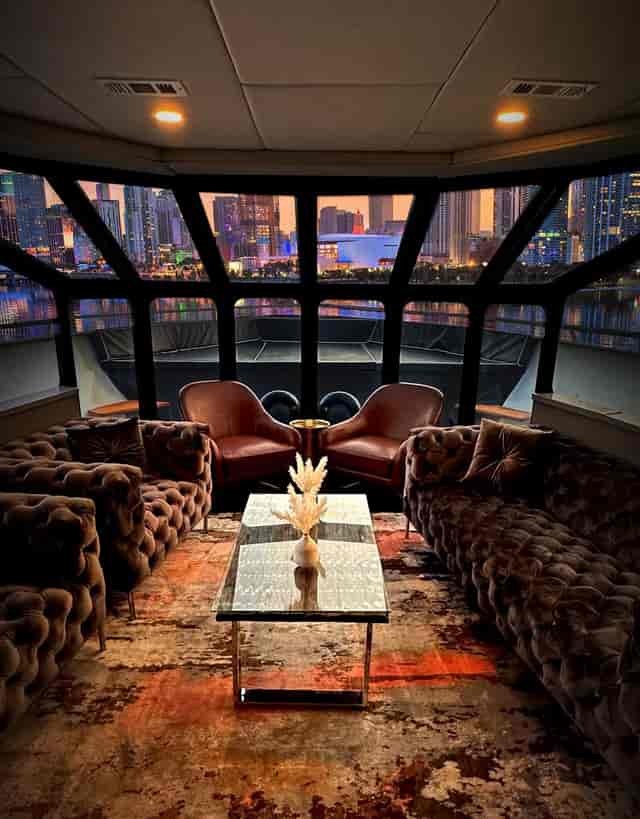 Luxury yacht lounge with panoramic skyline views, ideal for VIP networking and executive retreats.