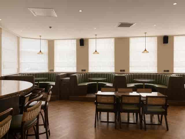Modern breakout space with modular booth seating for small team meetings and networking events.