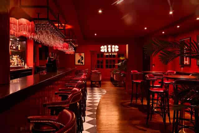 Upscale red-themed cocktail venue for exclusive VIP evening networking events.