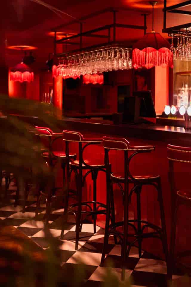 The 1907 moody red bar setup for intimate networking events and cocktail receptions.