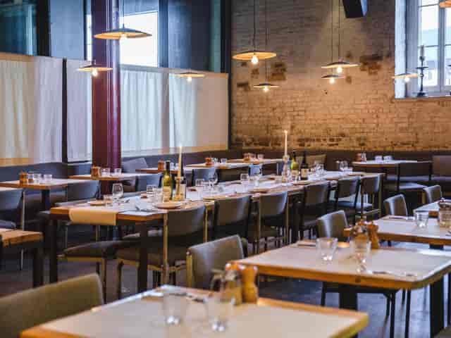 Industrial-chic Main Bar venue with exposed brick for corporate dinners and private events.