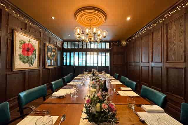Private dining room at The White Horse Wembley with wood paneling for VIP corporate events.