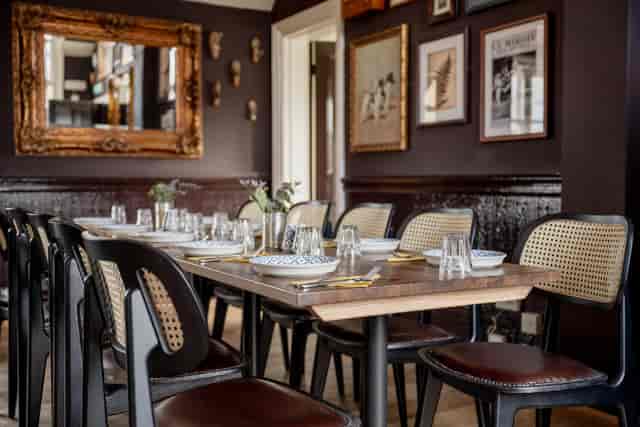 Private dining room at The Foresters featuring cane-back seating for upscale events.