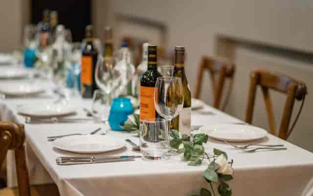 Banquet-style corporate dinner setup with floral tablescapes at The Turks Head event venue.