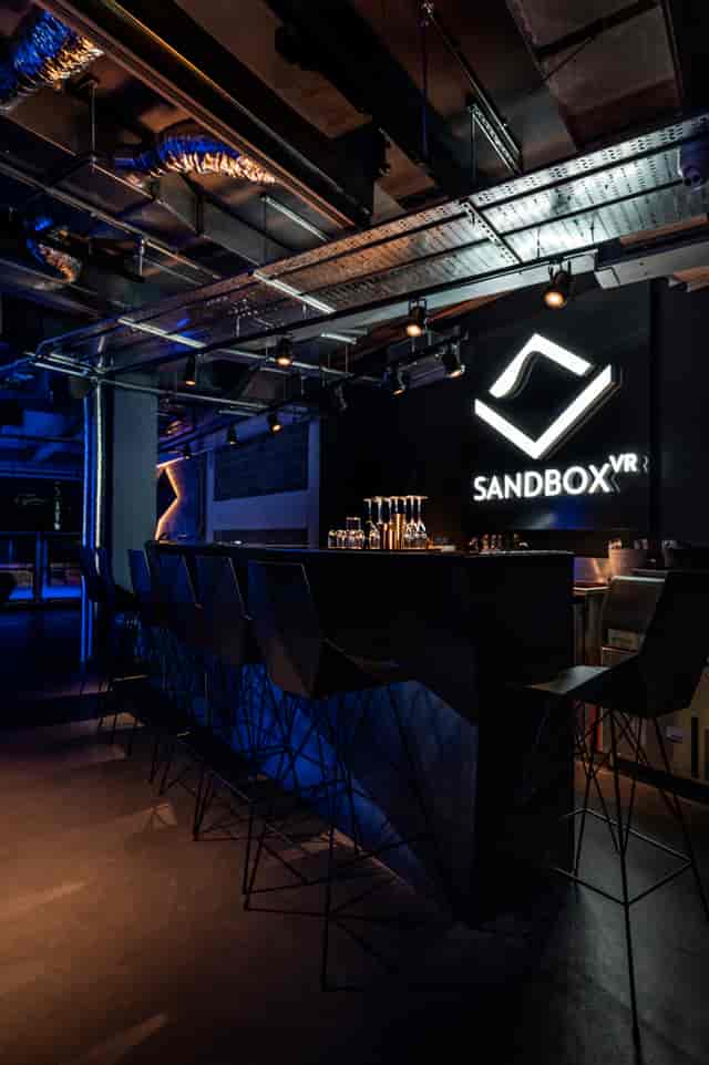 Modern branded bar in Sandbox VR London for corporate reception and tech-forward team building.