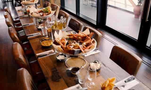 Captain's Table communal seafood dining at Big Easy Canary Wharf for team building and networking.