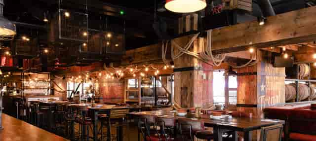 Rustic-industrial event space in Canary Wharf for networking mixers and team dinners.