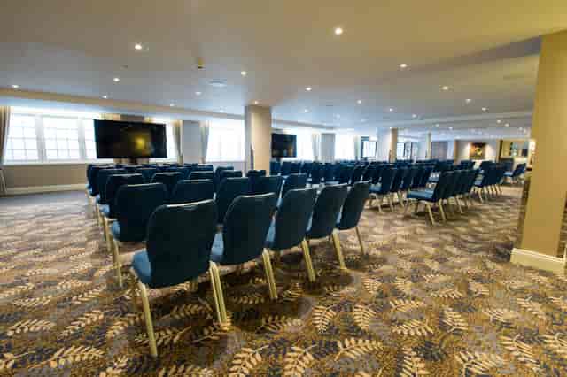 Theater-style conference room at Victory Services Club with structural pillars for event planning.